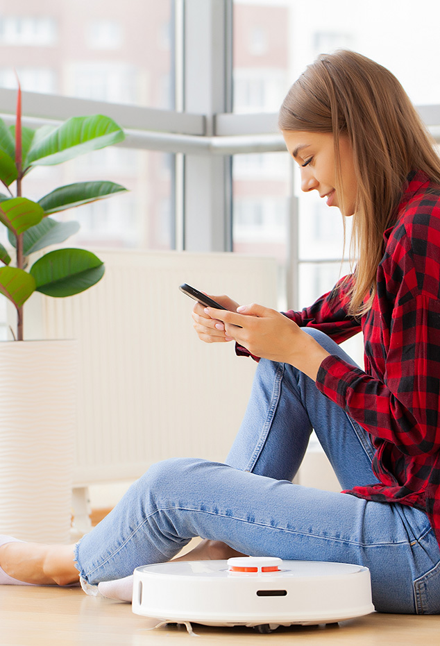 woman-turns-on-smart-robot-vacuum-cleaner